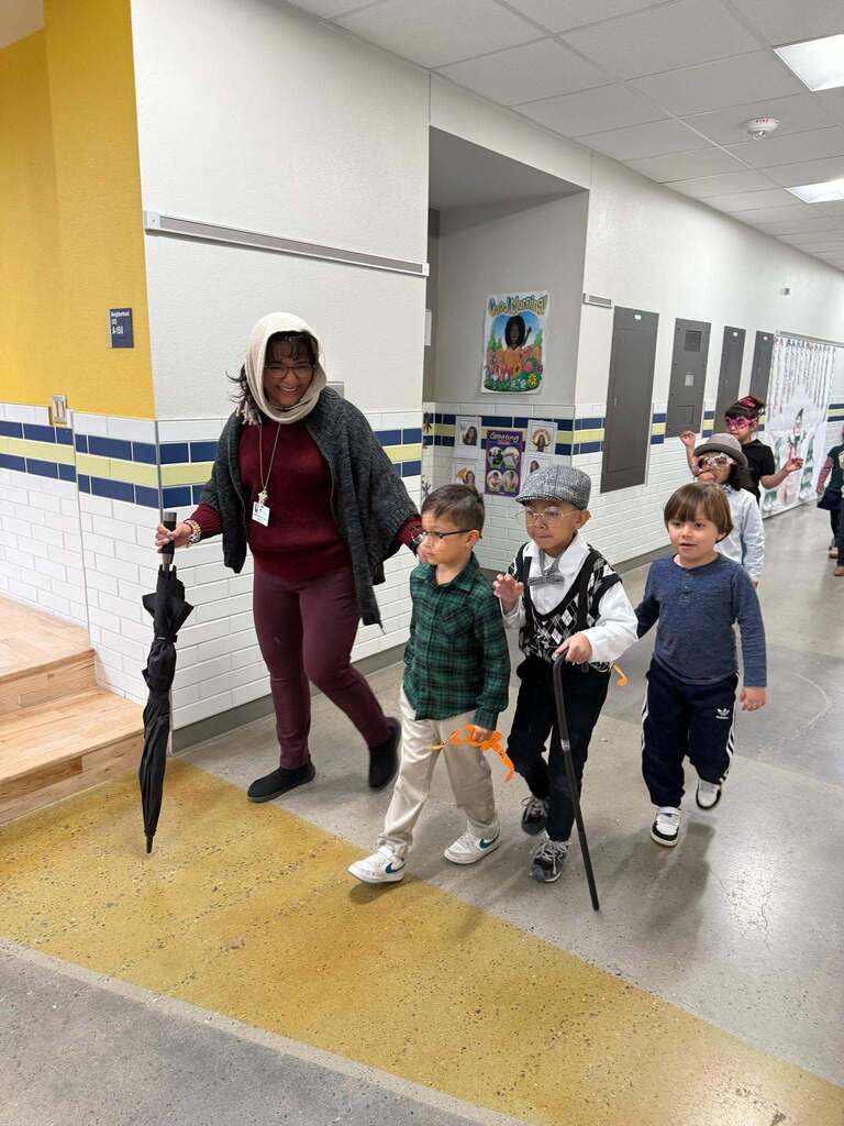 Murphree PK-8 students and teacher walk the halls dressed as 100 year old's for the 100th day of school