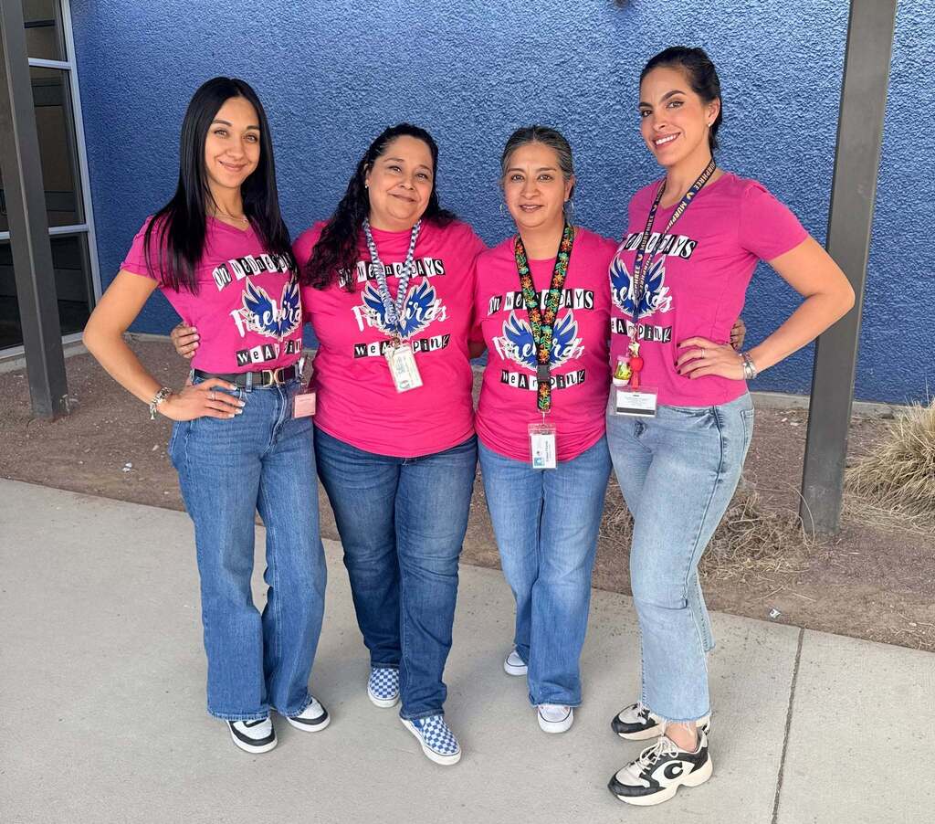Murphree PK-8 teachers smile for a group photo while wearing pink Murphree t-shirts