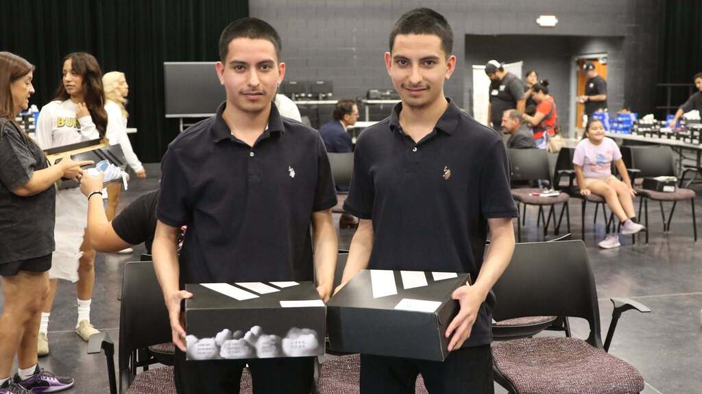 Student twins take photo with their new shoes