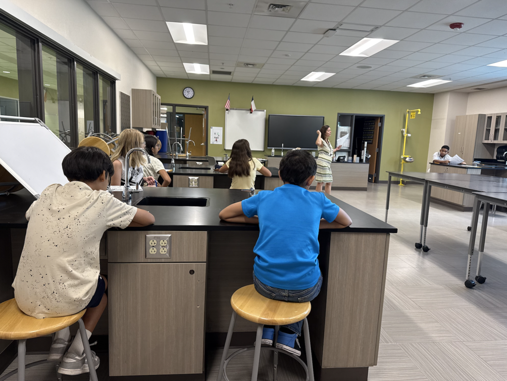 Haskins PK-8 students listening to a teacher in classroom