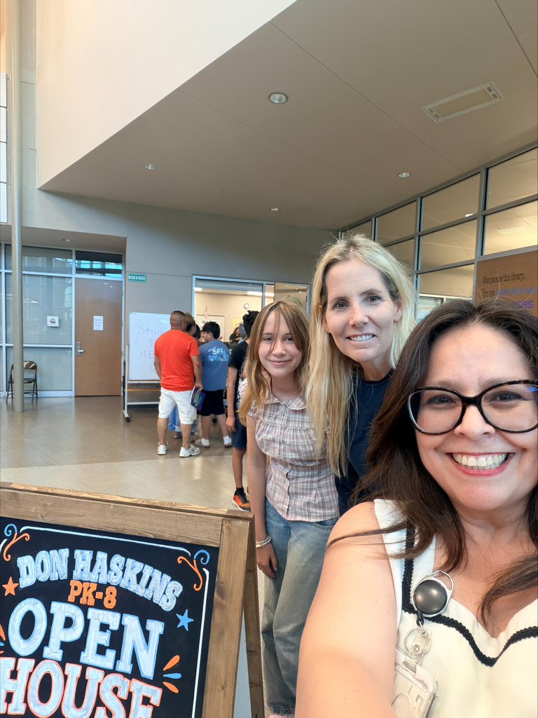Family and Haskins Assistant Principal smile for a photo at open house