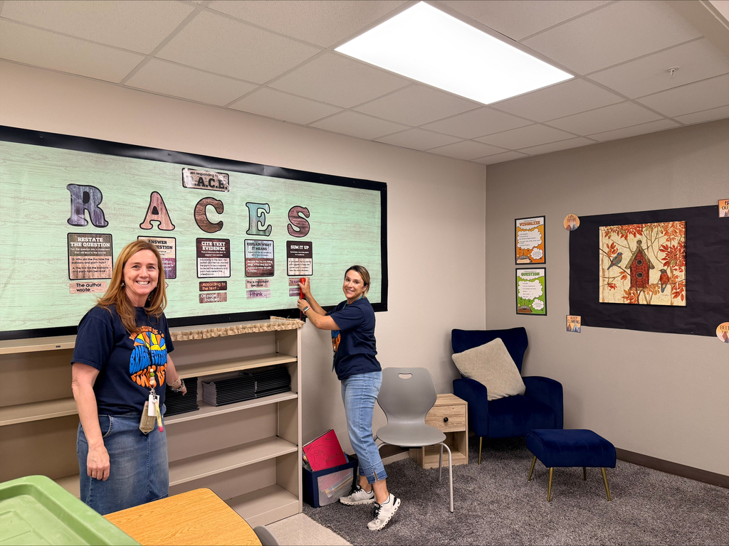 Teacher smiles for a photo while preparing for open house