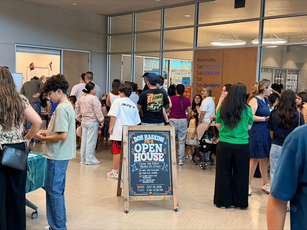 crowd hallway photo of crowded open house with Haskins PK-8 Open House sign