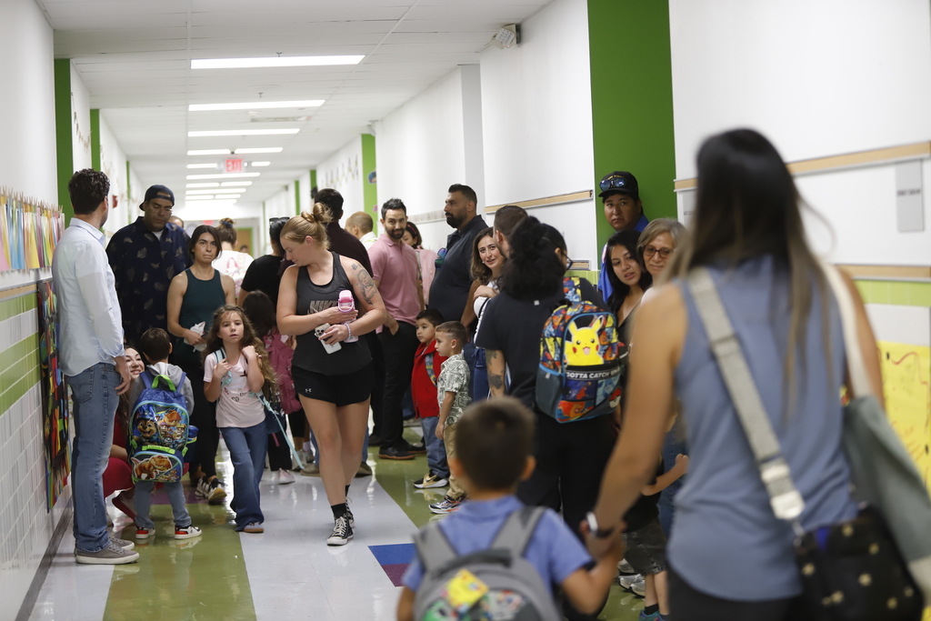 Lundy Elementary families guide children to their classrooms in hallway