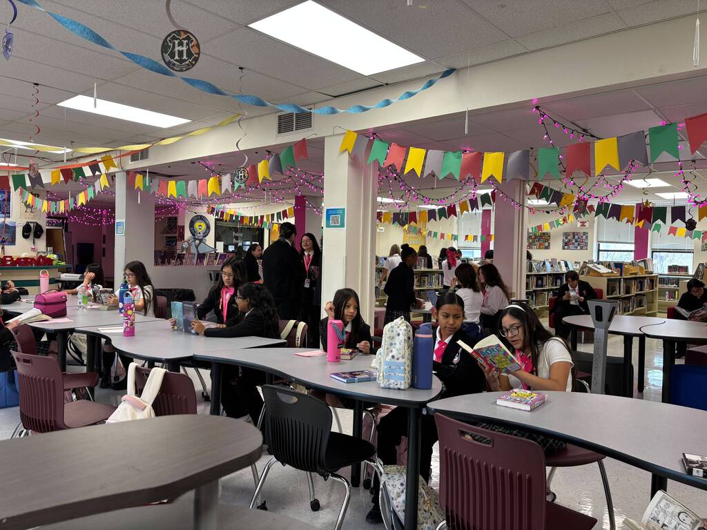 Students are siting down, talking, and working.