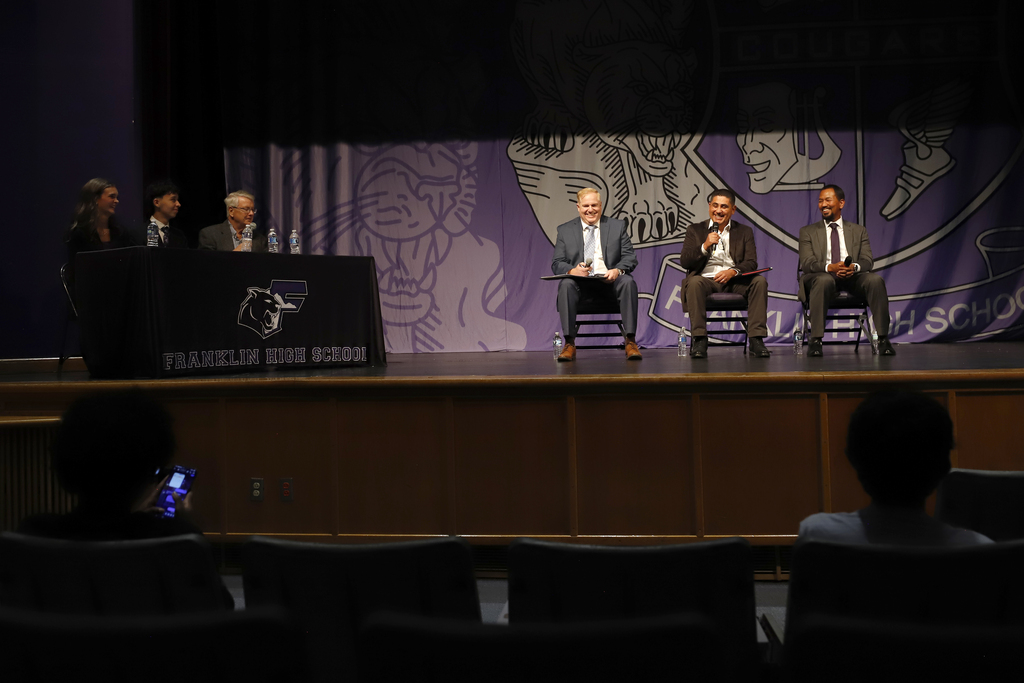 Picture of Candidates and student representatives on stage at candidate forum