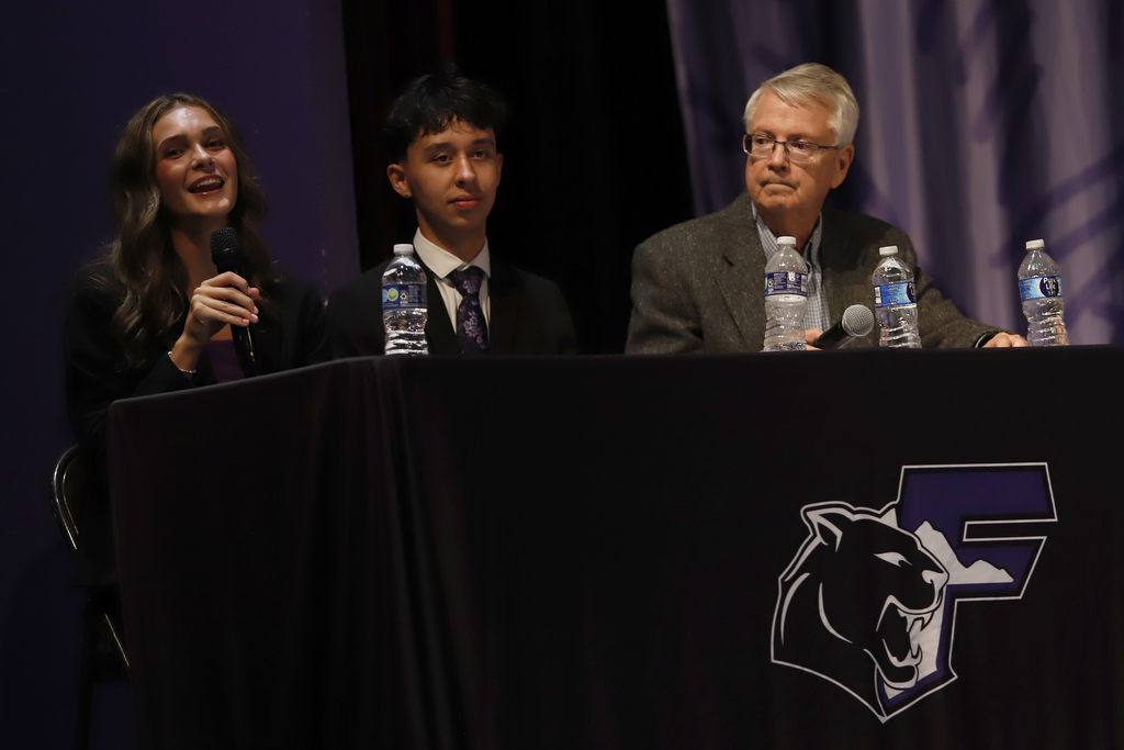 Picture of student representatives speaking on stage at candidate forum