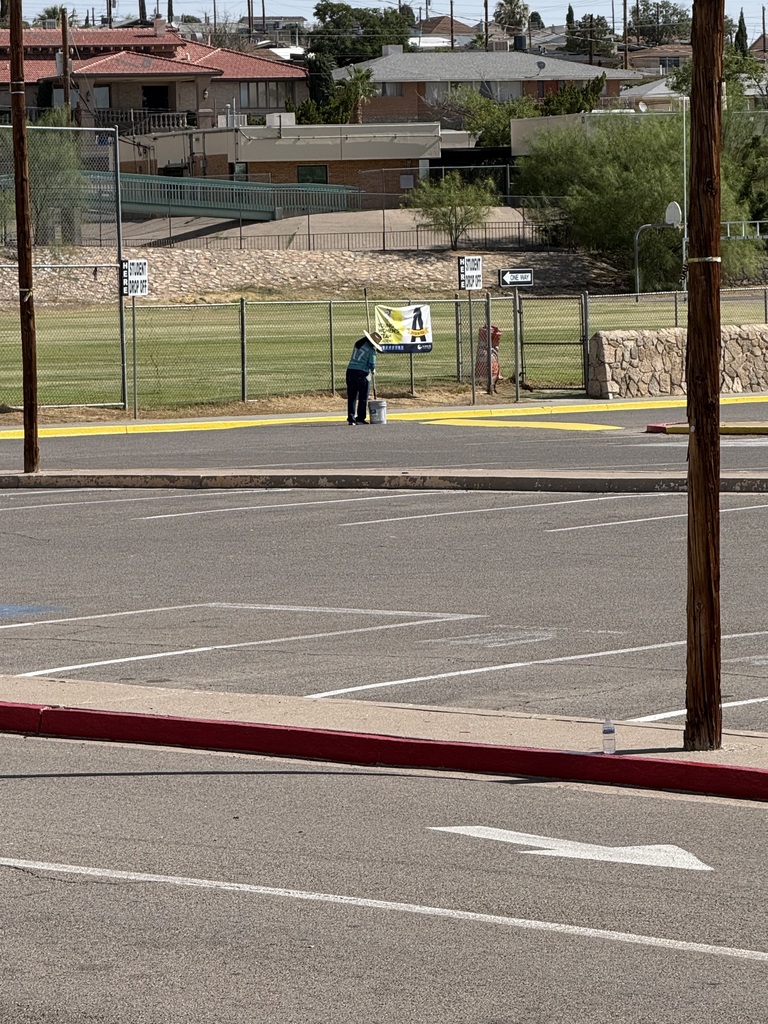 EPISD Operations worker repainting the bus lane