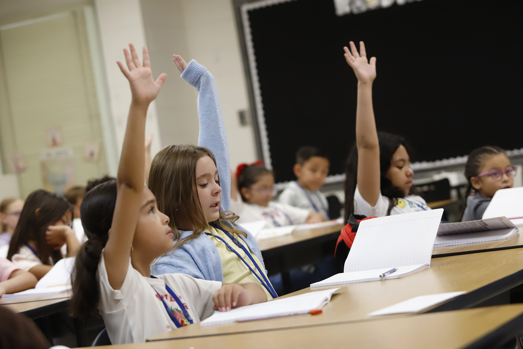 Students at Cielo Vista Elementary raising hands in class