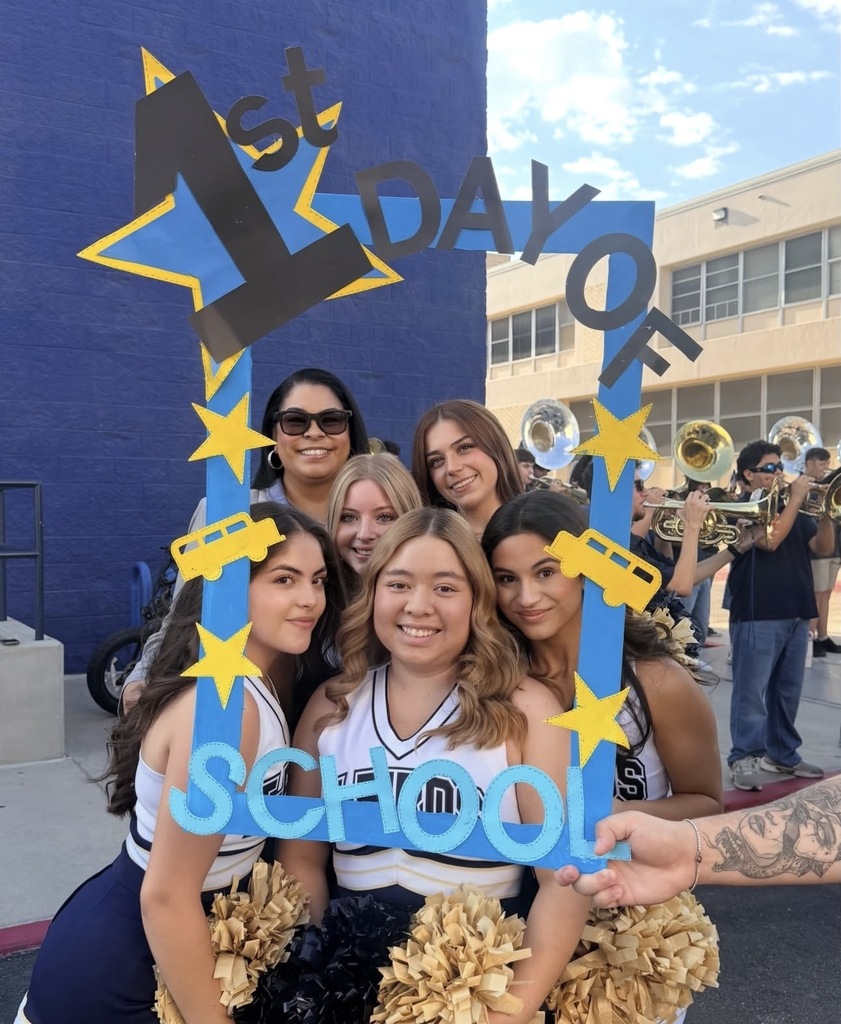 Coronado cheerleaders and principal pose with photo frame that says 1st day of school