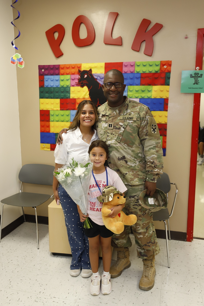 military family from surprise visit takes a family photo