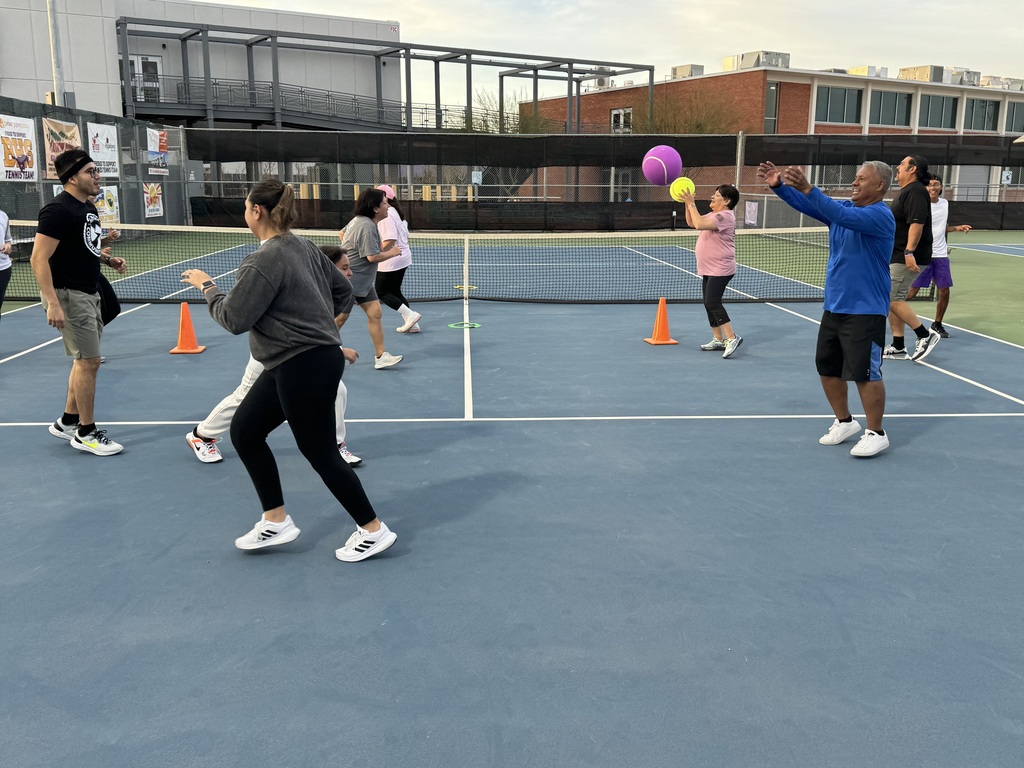 El Paso ISD employees working out on tennis courts running and passing giant tennis balls