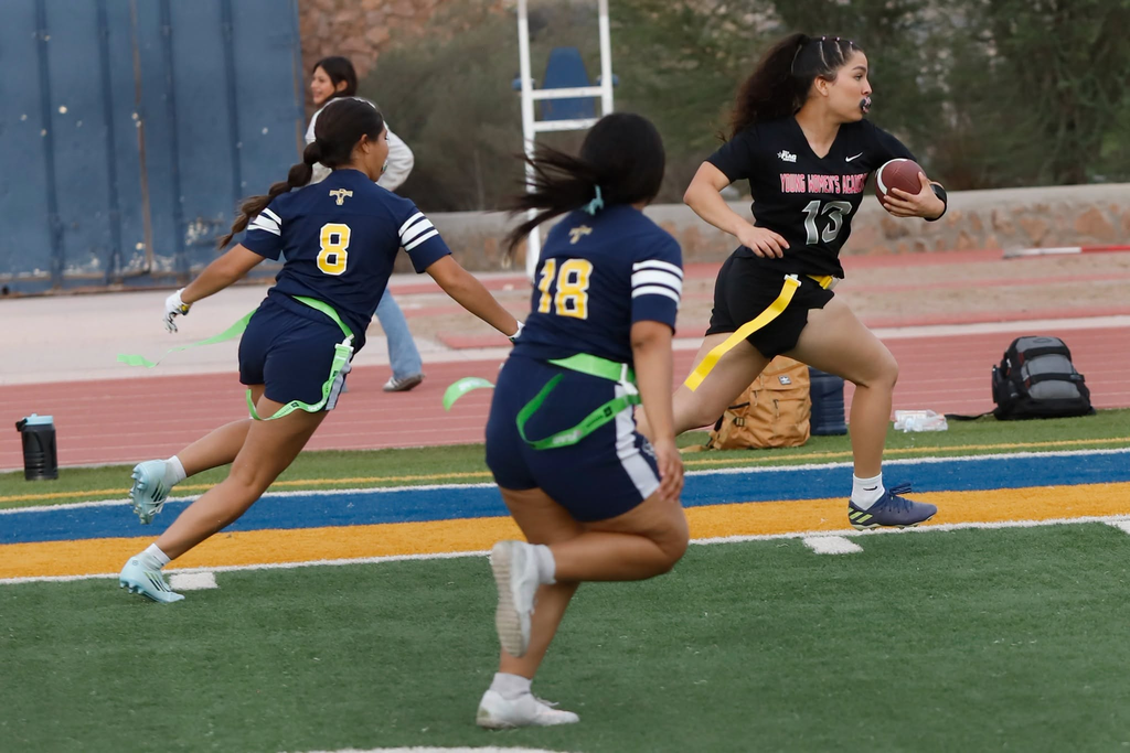 Young Womens Academy student athletes leads with the football running as Coronado athletes follow behind during flag football match