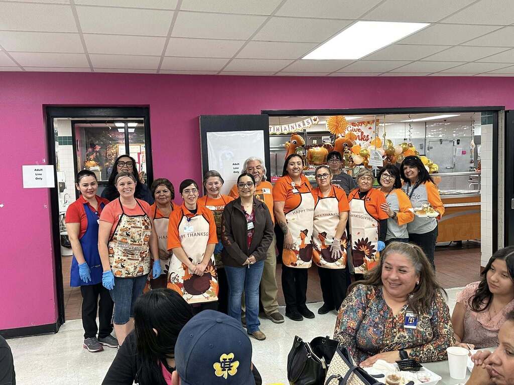 Volunteers smile for a photo after serving thanksgiving meals