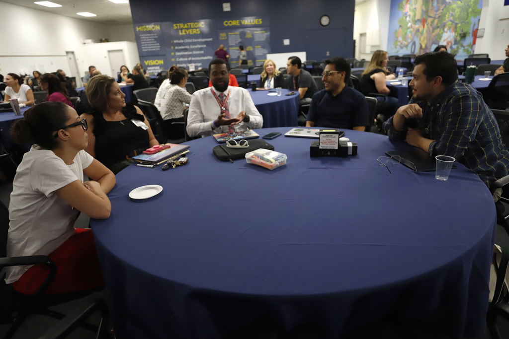Superintendent Teacher Advisory Council having a discussion at table