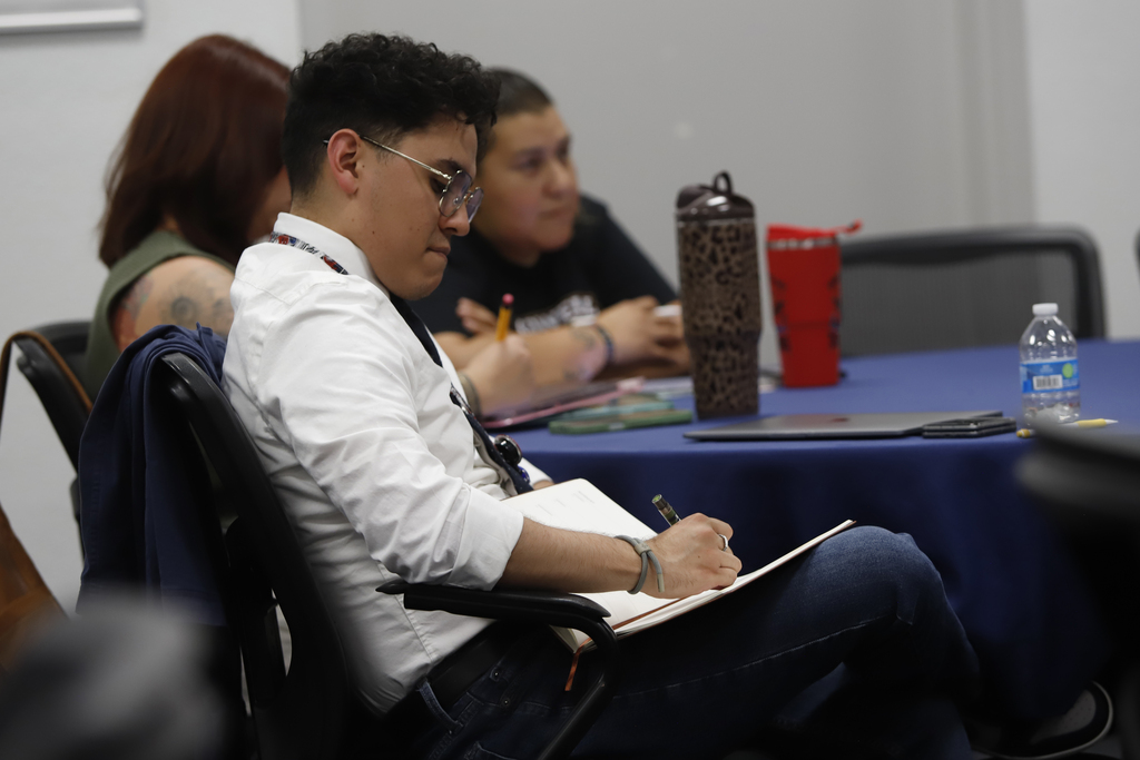 Superintendent Teacher Advisory Council take notes during presentation