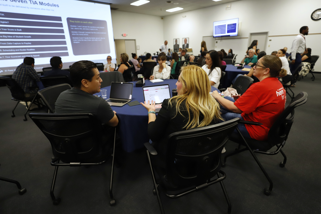 Superintendent Teacher Advisory Council having a discussion at table