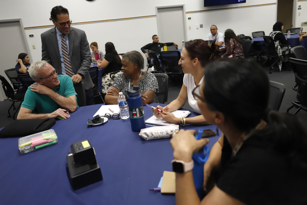 Superintendent Teacher Advisory Council having a discussion at table with Dr. Lusk
