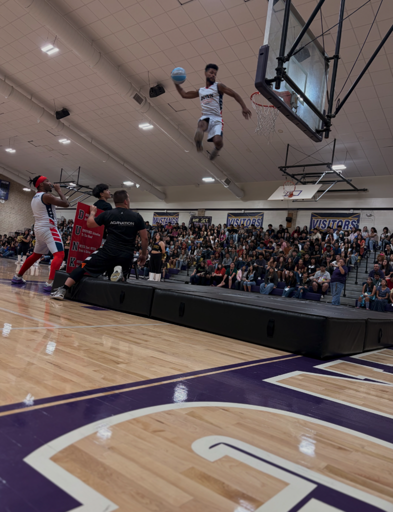 Photo of U.S. Army and Adrenaline Games Alliance (AGA Nation) basketball player high in the air as he scores a basket