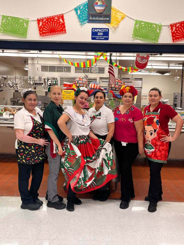 El Paso ISD staff members take a photo dress in Mexican Independence Day attire