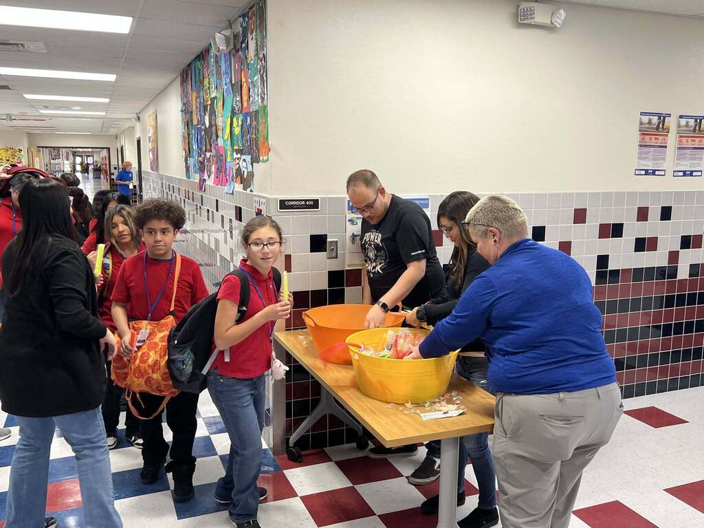 Magoffin Middle School 6th grade students wait in line to receive ice pops as incentive award for highest class attendance