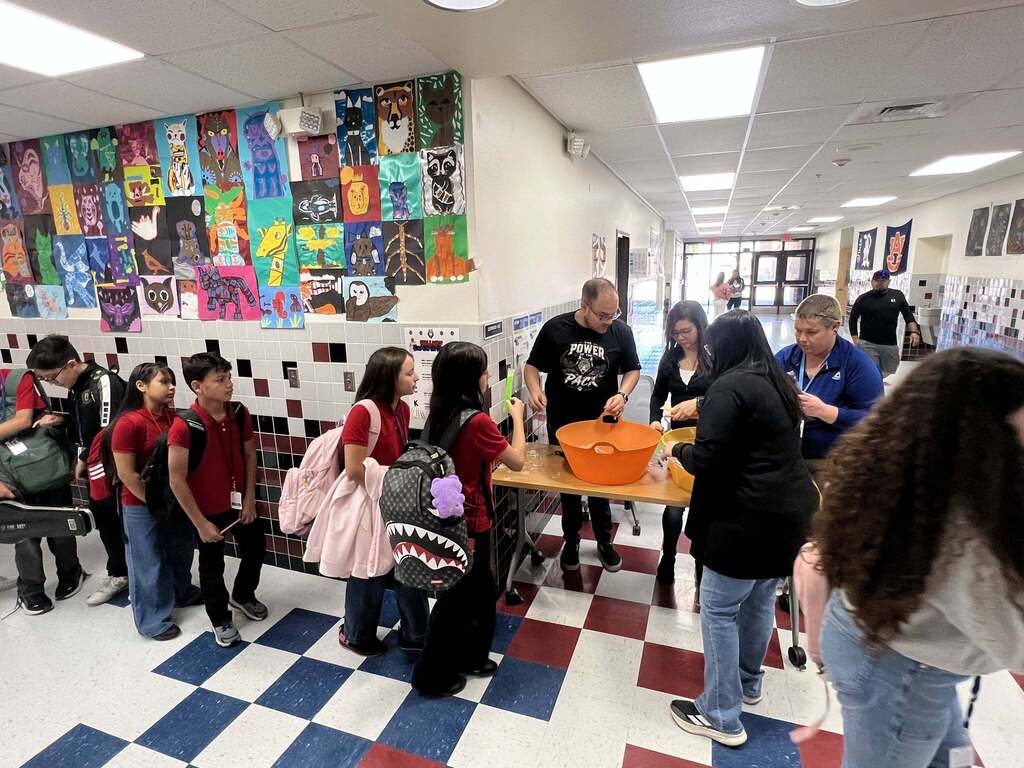 Magoffin Middle School 6th grade students wait in line to receive ice pops as incentive award for highest class attendance