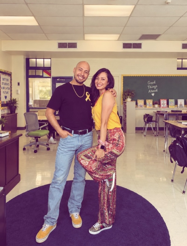 Staff smile for a photo dressed in gold for Childhood Cancer Awareness Month