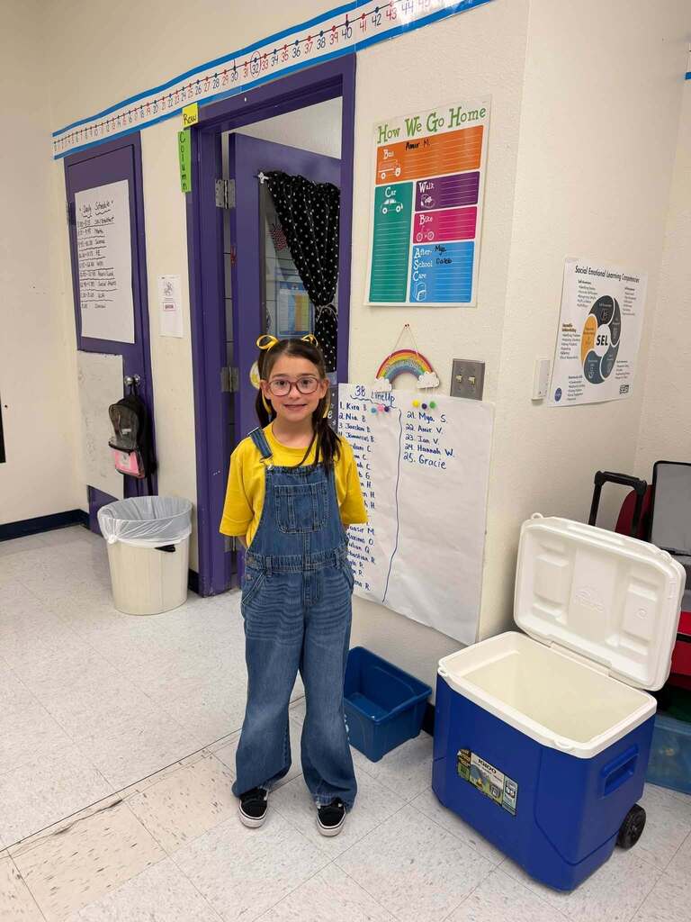 Student smile for a photo dressed in gold for Childhood Cancer Awareness Month