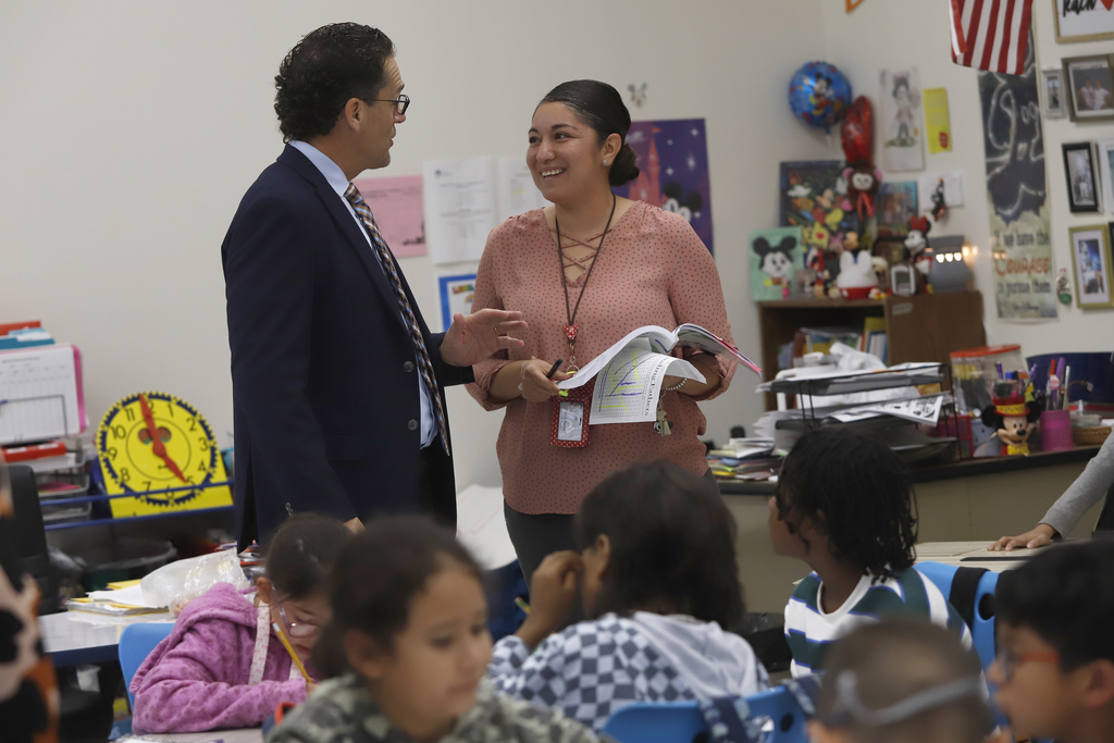 Superintendent Dr. Brian Lusk talks with a teacher