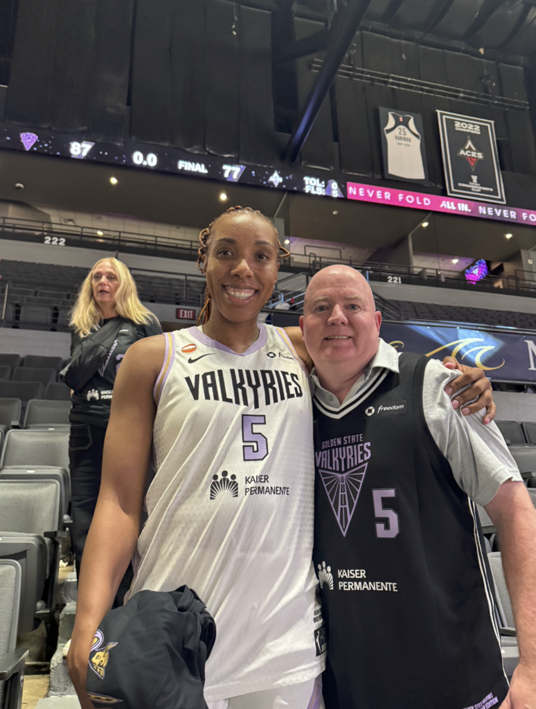 Kayla Thornton and Principal Robert Stives take photo after semifinals game