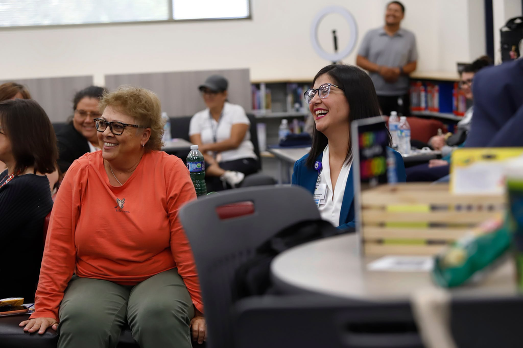 Hornedo Middle School principal laughs with staff members during staff meeting