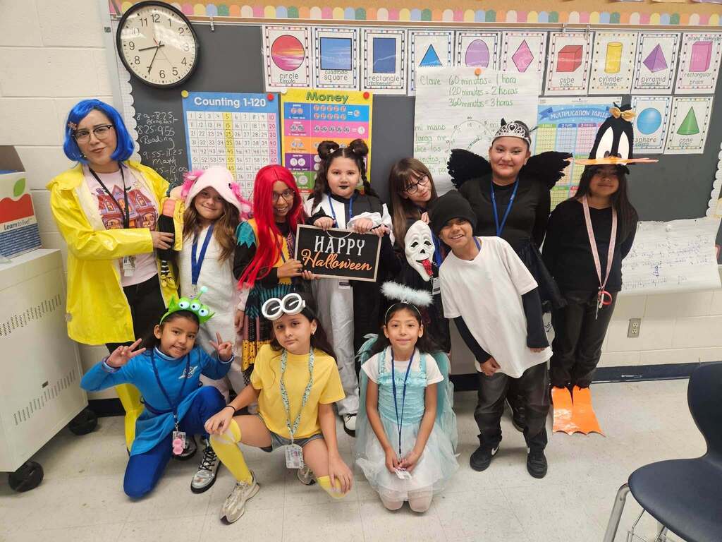 Classroom takes group photo dressed in halloween costumes