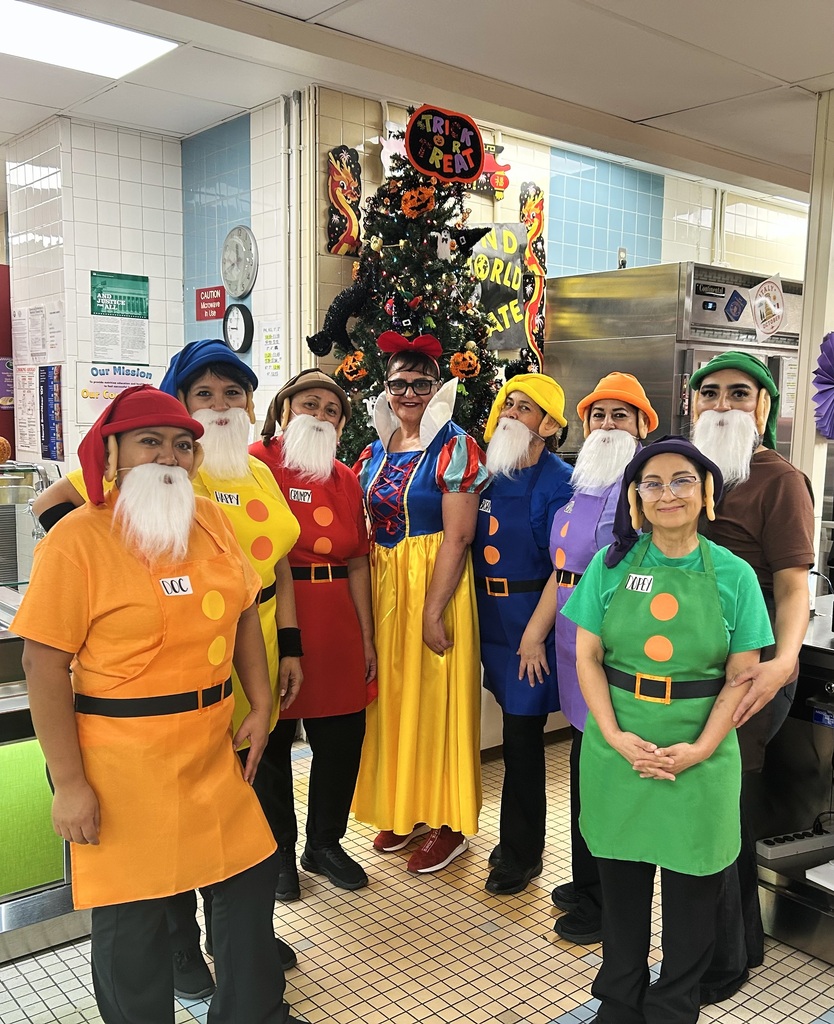 Cafeteria staff takes group photo dressed in Snow White and the Seven Dwarfs Costumes