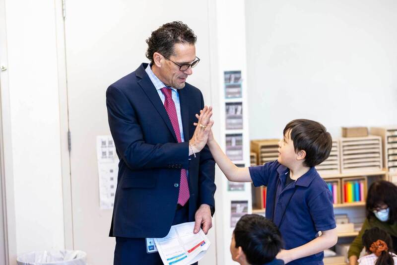 Dr Lusk high fives a student