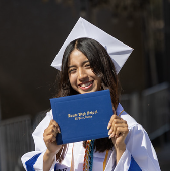 a graduate holds her diploma
