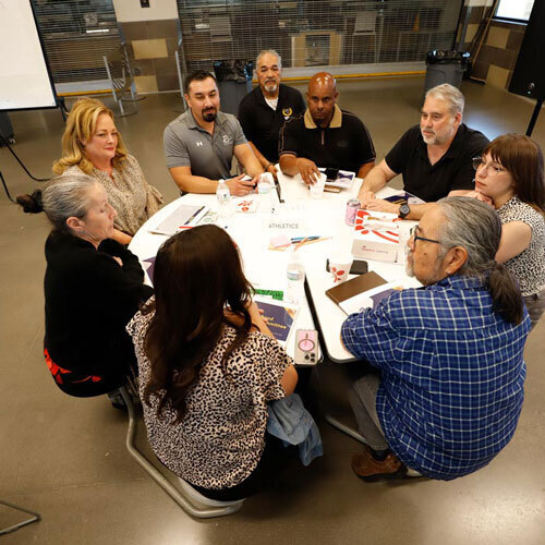 Participants sit around a table