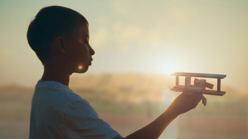 a child holds a toy airplane
