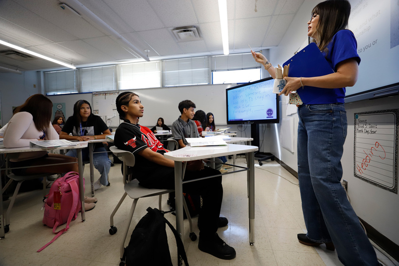 a teacher stands in front of a classroom