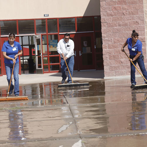 An image of custodians outside a school