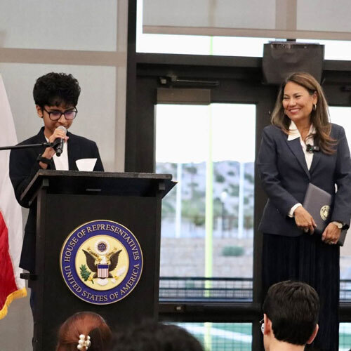 A student stands at a podium