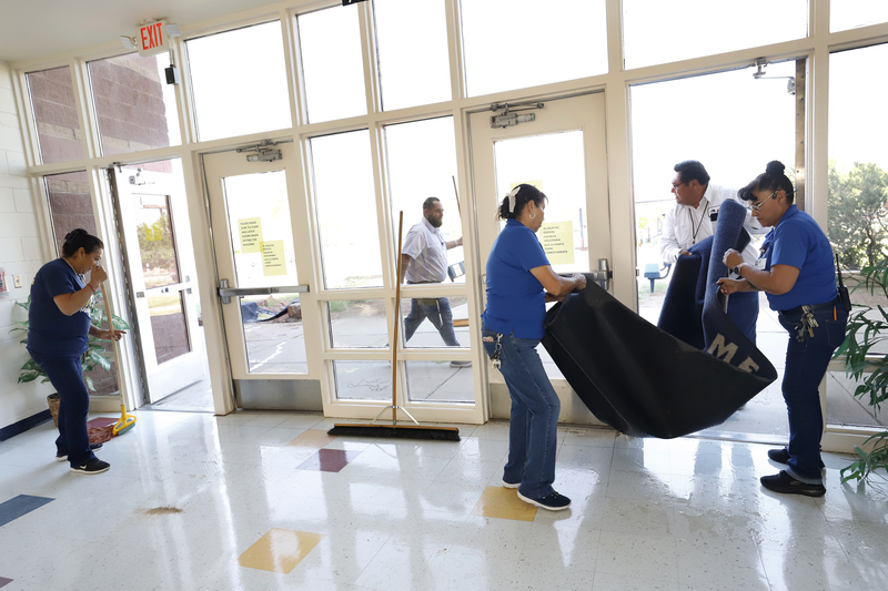 Custodial teams work together to cleanup after rainfall
