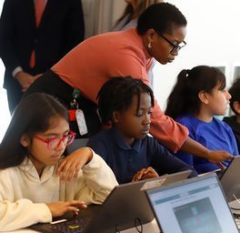 Teacher instructing students at a lab