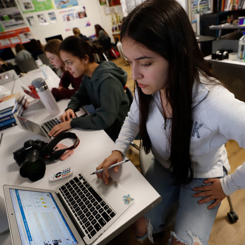 A student looks at her computer