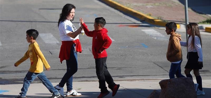Moreno Middle School Principal Angelic Lopez high-fives students during the Happy Mile Wellness initiative
