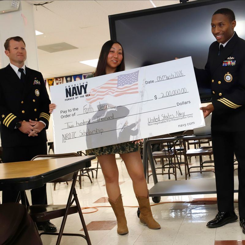 A student holds a check