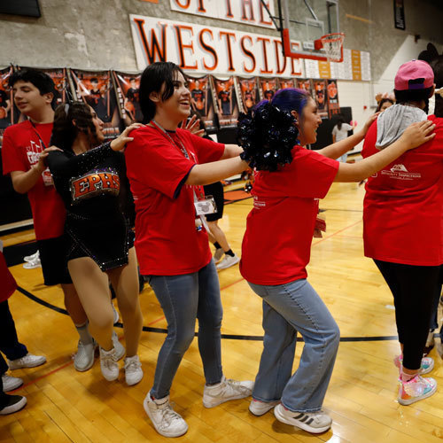 Students dance in a conga line