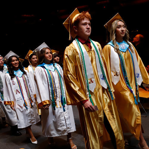 Students walk at graduation