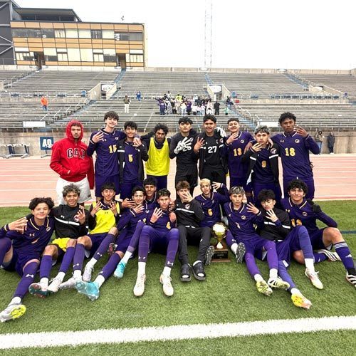 Soccer athletes pose for a camera