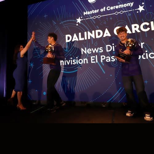 people stand on the State of the District stage