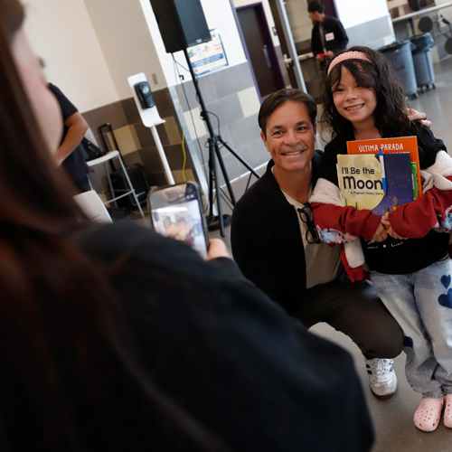 A student poses with an author